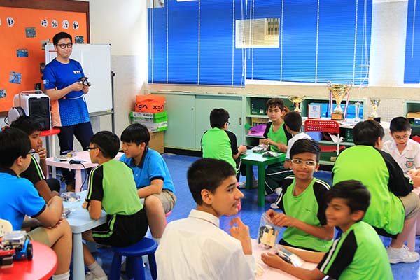 Frank tutors a classroom full of students from different ethnic backgrounds. 